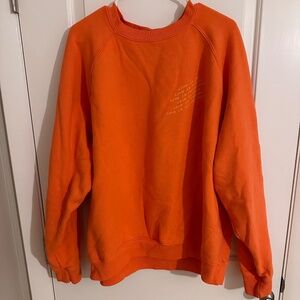Uninterrupted orange crewneck